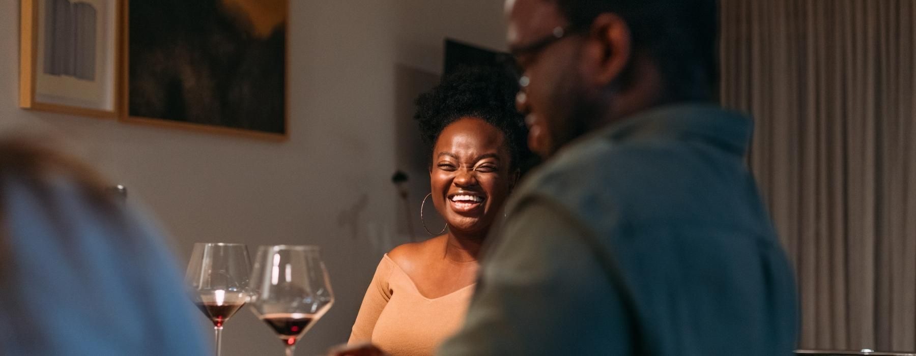 a group of people sitting at a table with wine glasses