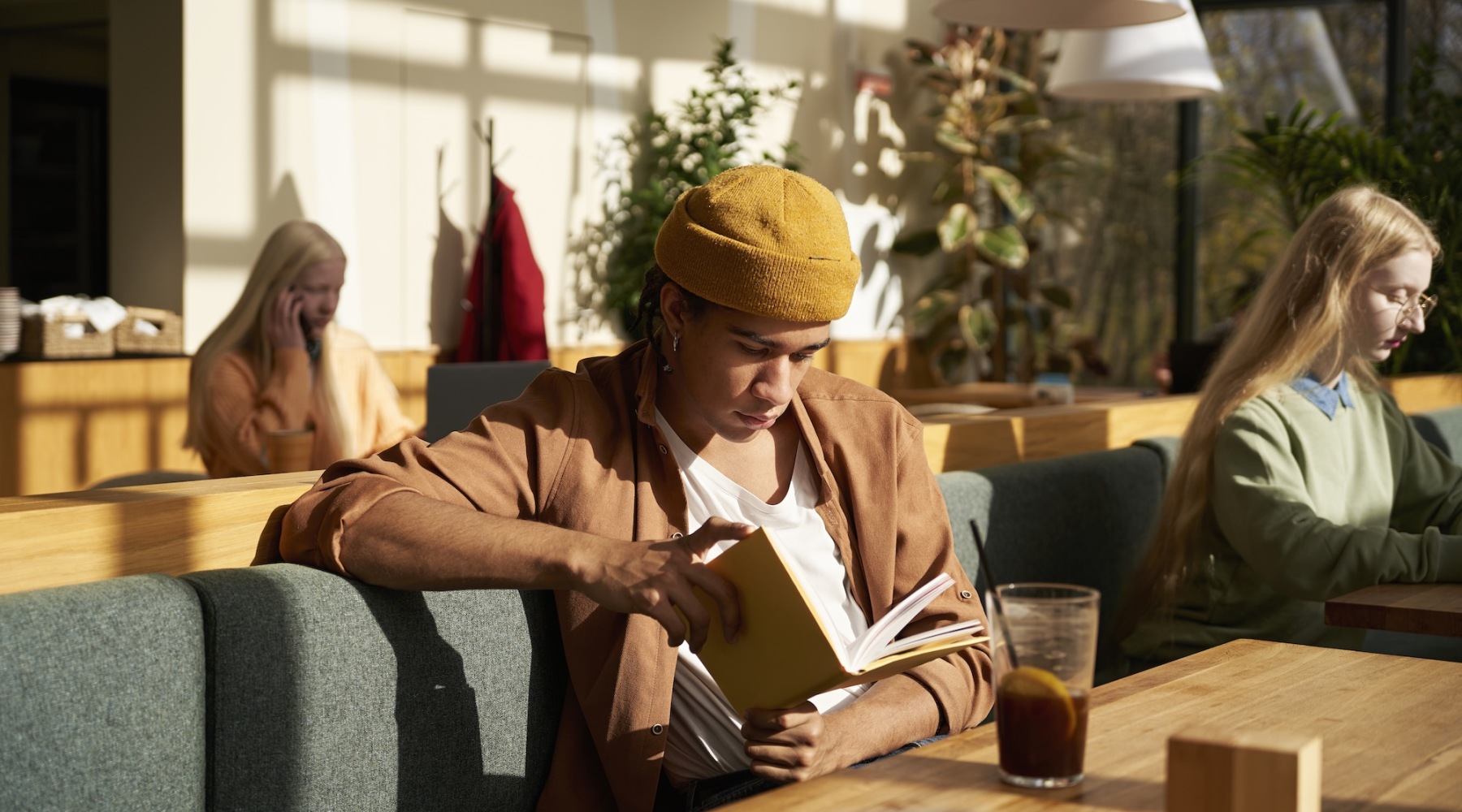 a person in a hat reading a book